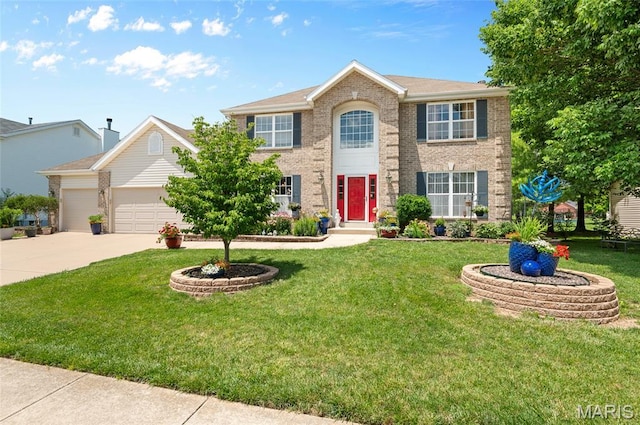 2235 Arnold Palmer Dr, Belleville, IL 62220 - colonial home with concrete driveway, brick siding, an attached garage, and a front lawn