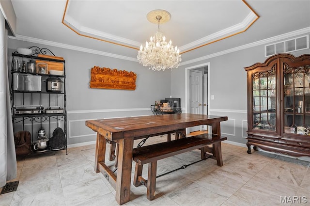 2235 Arnold Palmer Dr, Belleville, IL 62220 - dining space with a tray ceiling, a chandelier, crown molding, and light marble finish flooring