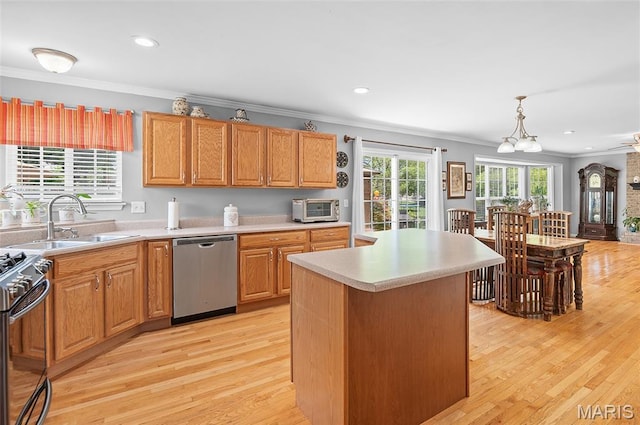 2235 Arnold Palmer Dr, Belleville, IL 62220 - kitchen featuring stainless steel appliances, crown molding, light countertops, light wood-type flooring, and a kitchen island