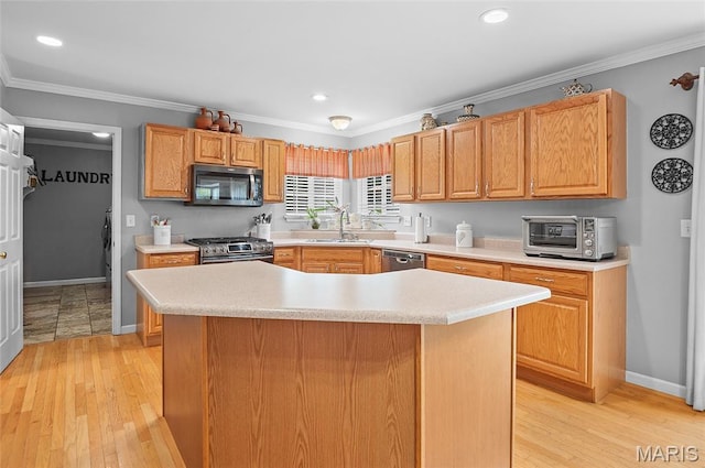 2235 Arnold Palmer Dr, Belleville, IL 62220 - kitchen featuring appliances with stainless steel finishes, light countertops, light wood-type flooring, ornamental molding, and a center island