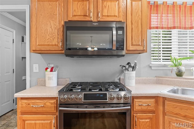 2235 Arnold Palmer Dr, Belleville, IL 62220 - kitchen featuring gas range, crown molding, and light countertops