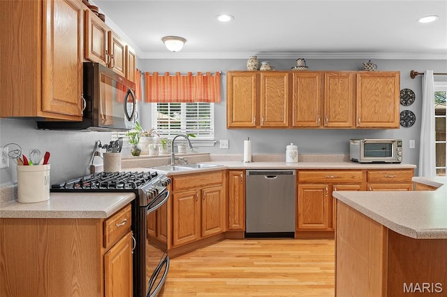 2235 Arnold Palmer Dr, Belleville, IL 62220 - kitchen featuring stainless steel appliances, ornamental molding, light countertops, light wood-style floors, and recessed lighting