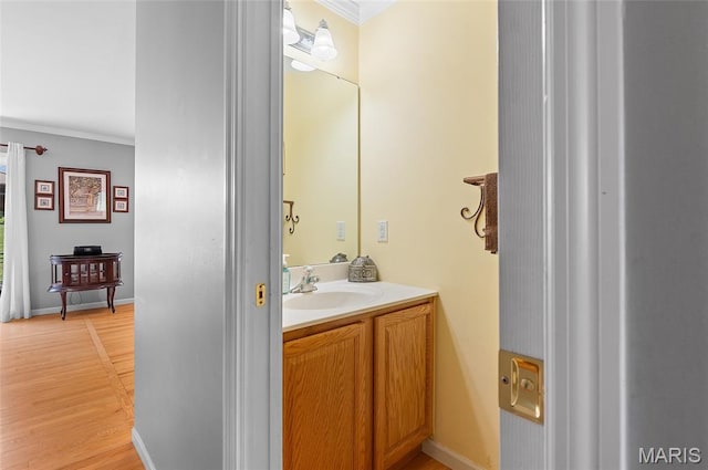 2235 Arnold Palmer Dr, Belleville, IL 62220 - half bathroom with vanity, ornamental molding, and wood finished floors