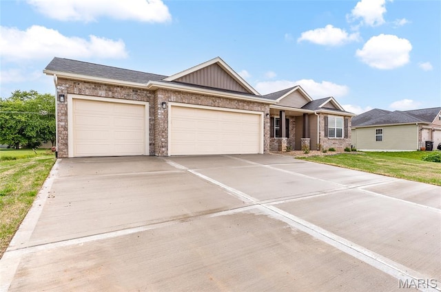 225 Ranchero Dr, Hamel, IL 62046 - view of front of home featuring an attached garage, concrete driveway, a front lawn, board and batten siding, and brick siding
