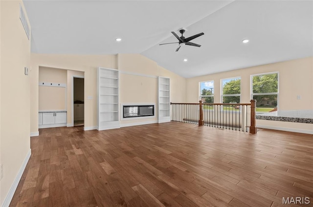 225 Ranchero Dr, Hamel, IL 62046 - unfurnished living room with lofted ceiling, wood finished floors, ceiling fan, built in shelves, and a glass covered fireplace