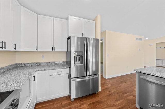 225 Ranchero Dr, Hamel, IL 62046 - kitchen featuring stainless steel appliances, dark wood-type flooring, white cabinetry, and light stone countertops
