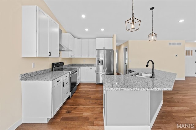 225 Ranchero Dr, Hamel, IL 62046 - kitchen featuring stainless steel appliances, under cabinet range hood, dark wood-style floors, an island with sink, and white cabinetry