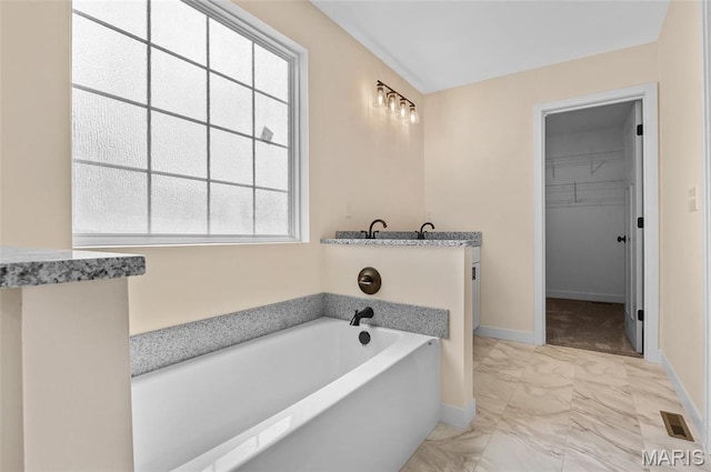225 Ranchero Dr, Hamel, IL 62046 - full bathroom featuring marble look tile flooring, a bath, and a walk in closet