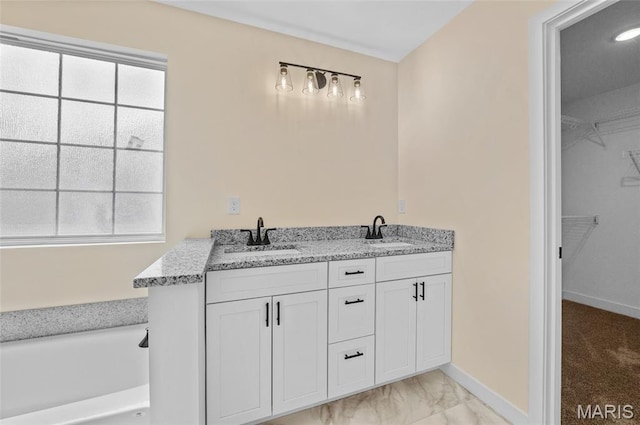225 Ranchero Dr, Hamel, IL 62046 - bathroom with marble look tile flooring, a walk in closet, a bath, and double vanity