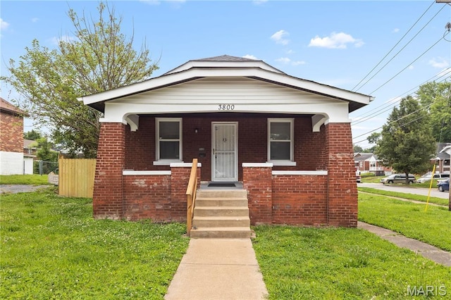 3800 Oakridge Blvd, Northwoods, MO 63121 - view of front facade featuring brick siding and covered porch