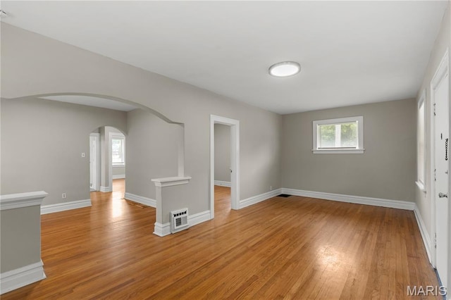 3800 Oakridge Blvd, Northwoods, MO 63121 - empty room featuring light wood-style floors, healthy amount of natural light, and arched walkways