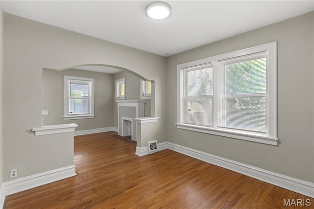 3800 Oakridge Blvd, Northwoods, MO 63121 - empty room featuring wood finished floors and arched walkways