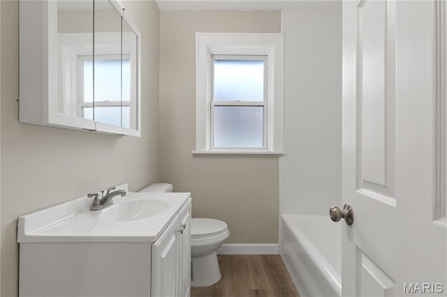 3800 Oakridge Blvd, Northwoods, MO 63121 - full bathroom with vanity, plenty of natural light, a bathtub, and wood finished floors