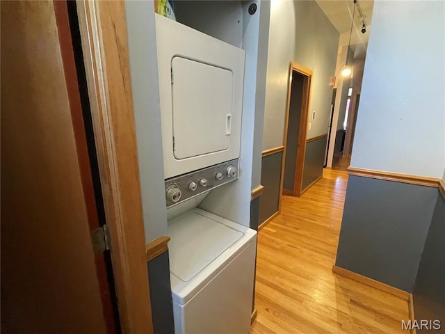 2319 Hickory St Unit A, Saint Louis, MO 63104 - laundry area with stacked washing machine and dryer and light wood finished floors