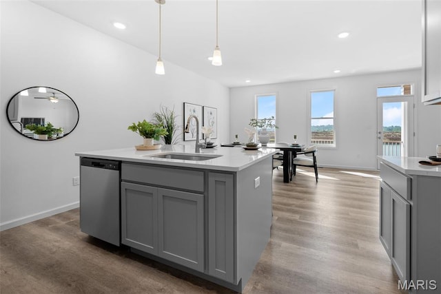 3059 Pirogue St, Saint Charles, MO 63301 - kitchen with gray cabinets, stainless steel dishwasher, light countertops, plenty of natural light, and recessed lighting