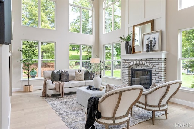 851 Whitmoor Dr, Weldon Spring, MO 63304 - living room with a towering ceiling, a fireplace, and light wood-style flooring