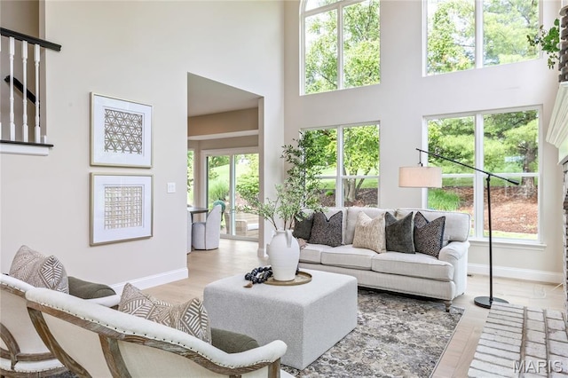 851 Whitmoor Dr, Weldon Spring, MO 63304 - living room featuring a high ceiling, healthy amount of natural light, and light wood-type flooring