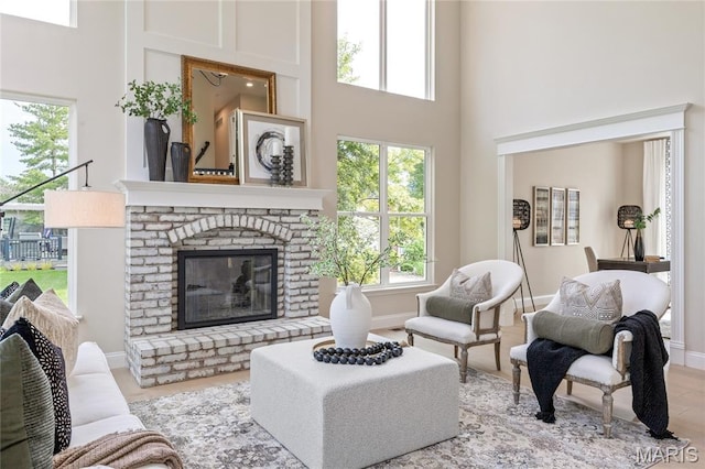 851 Whitmoor Dr, Weldon Spring, MO 63304 - living area featuring a towering ceiling, healthy amount of natural light, and a fireplace