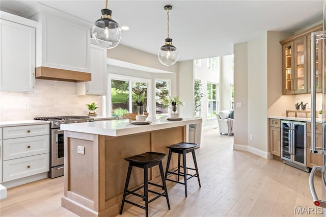 851 Whitmoor Dr, Weldon Spring, MO 63304 - kitchen with stainless steel range with gas stovetop, beverage cooler, healthy amount of natural light, tasteful backsplash, and recessed lighting