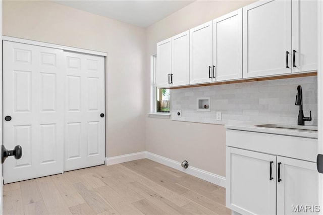 851 Whitmoor Dr, Weldon Spring, MO 63304 - washroom featuring washer hookup, light wood-style flooring, cabinet space, and hookup for an electric dryer