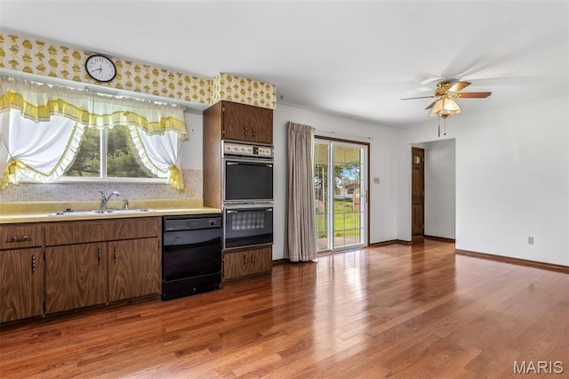 2844 Deborah Ann Dr, Arnold, MO 63010 - kitchen featuring black appliances, light countertops, wood finished floors, and ceiling fan