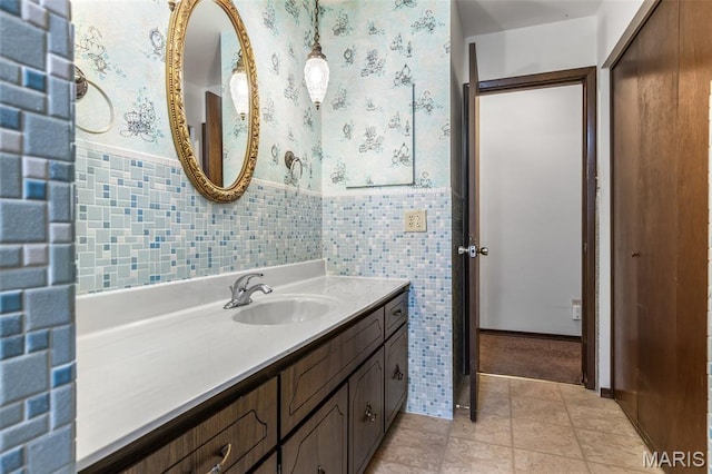 2844 Deborah Ann Dr, Arnold, MO 63010 - bathroom with vanity, wainscoting, tile patterned flooring, tile walls, and wallpapered walls