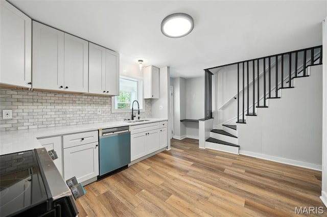 4550 Enright Ave, Saint Louis, MO 63108 - kitchen featuring dishwasher, decorative backsplash, light wood-style flooring, electric stove, and light countertops