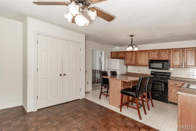 18 Novella Dr, Saint Peters, MO 63376 - kitchen with black appliances, a ceiling fan, a chandelier, decorative backsplash, and a breakfast bar area