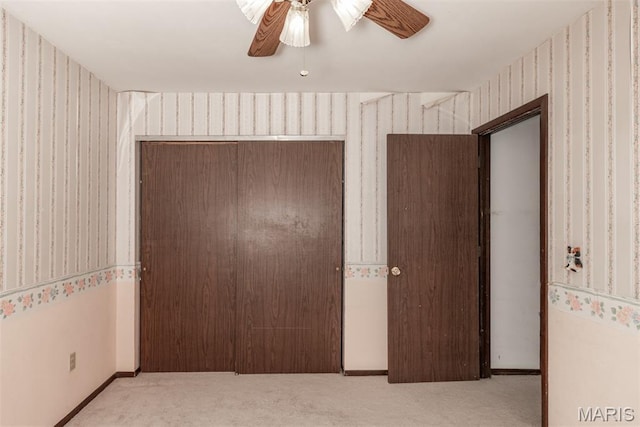 18 Novella Dr, Saint Peters, MO 63376 - unfurnished bedroom with wallpapered walls, carpet, a closet, and a ceiling fan