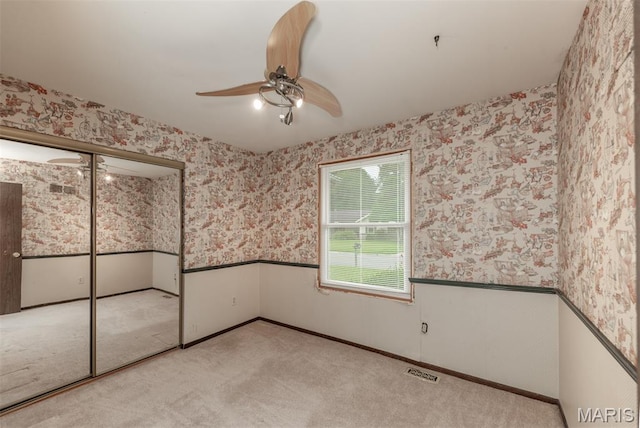 18 Novella Dr, Saint Peters, MO 63376 - unfurnished bedroom featuring wallpapered walls, wainscoting, carpet floors, and ceiling fan