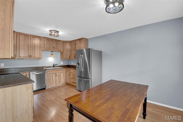 818 Sugar Valley Ct, Saint Peters, MO 63376 - kitchen featuring stainless steel appliances, dark countertops, light wood-type flooring, and light brown cabinets