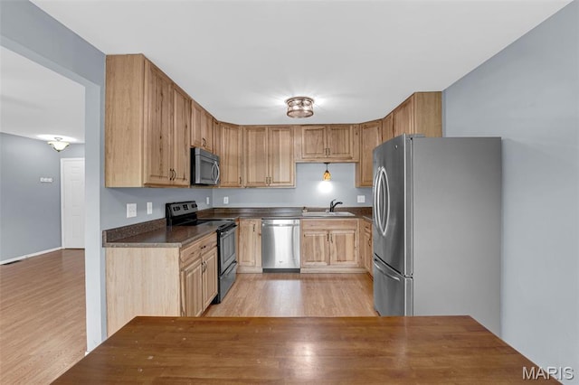 818 Sugar Valley Ct, Saint Peters, MO 63376 - kitchen featuring appliances with stainless steel finishes, light wood finished floors, and dark countertops
