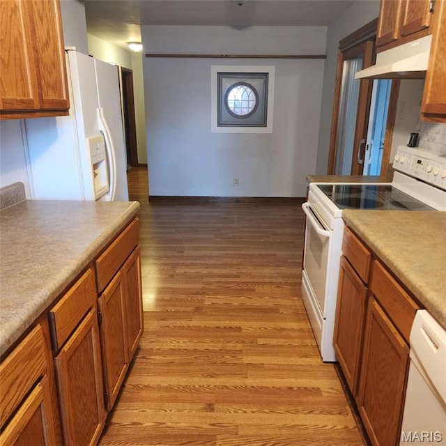 6380 Dolde Rd, Cedar Hill, MO 63016 - kitchen with white appliances, under cabinet range hood, light wood-type flooring, and brown cabinetry