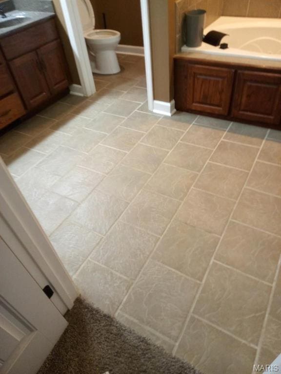 1107 Daffodil St, Sikeston, MO 63801 - bathroom featuring a bath and tile patterned floors