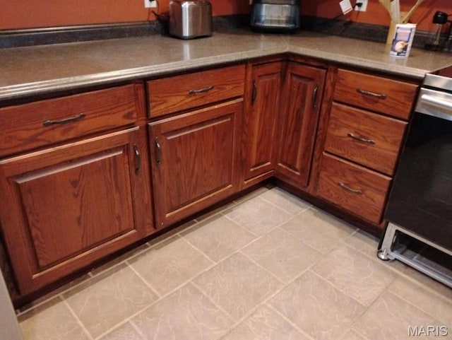 1107 Daffodil St, Sikeston, MO 63801 - kitchen with stainless steel range oven and brown cabinets
