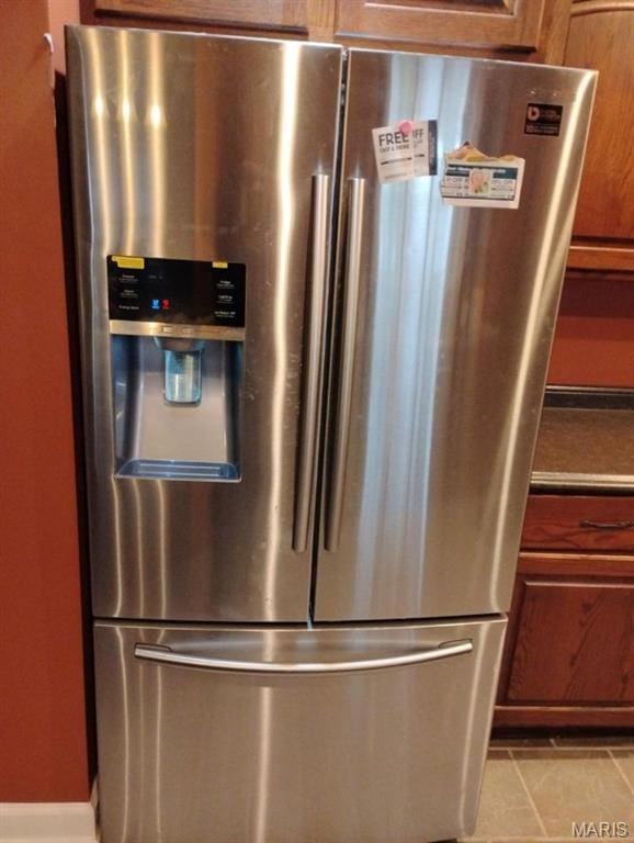 1107 Daffodil St, Sikeston, MO 63801 - kitchen view of stainless steel fridge with ice dispenser and brown cabinetry