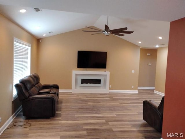 1107 Daffodil St, Sikeston, MO 63801 - living room featuring a ceiling fan, light wood-style floors, a fireplace, lofted ceiling, and recessed lighting