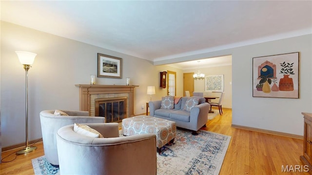 9334 Litzsinger Rd, Rock Hill, MO 63144 - living area featuring a chandelier, light wood-style floors, and a brick fireplace