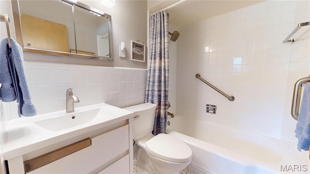 9334 Litzsinger Rd, Rock Hill, MO 63144 - full bathroom featuring shower / tub combo, vanity, tile walls, and wainscoting
