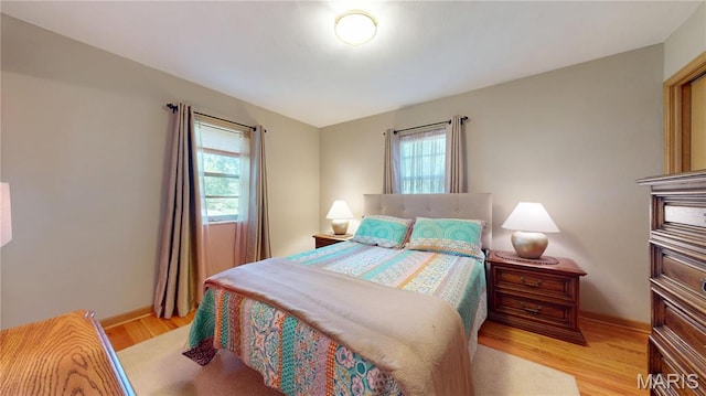 9334 Litzsinger Rd, Rock Hill, MO 63144 - bedroom with light wood-style floors and baseboards