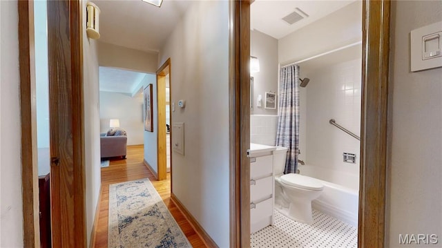 9334 Litzsinger Rd, Rock Hill, MO 63144 - bathroom with shower / tub combo, vanity, and wood finished floors