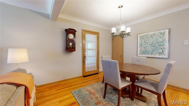 9334 Litzsinger Rd, Rock Hill, MO 63144 - dining room with a chandelier and light wood finished floors
