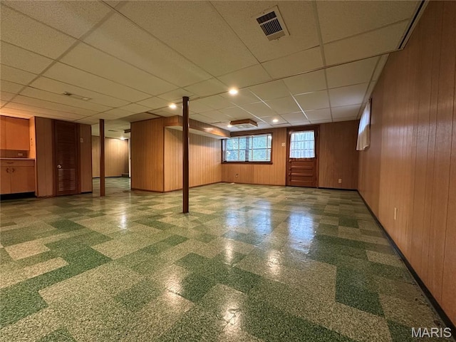 9334 Litzsinger Rd, Rock Hill, MO 63144 - basement with tile patterned floors, wooden walls, and a drop ceiling