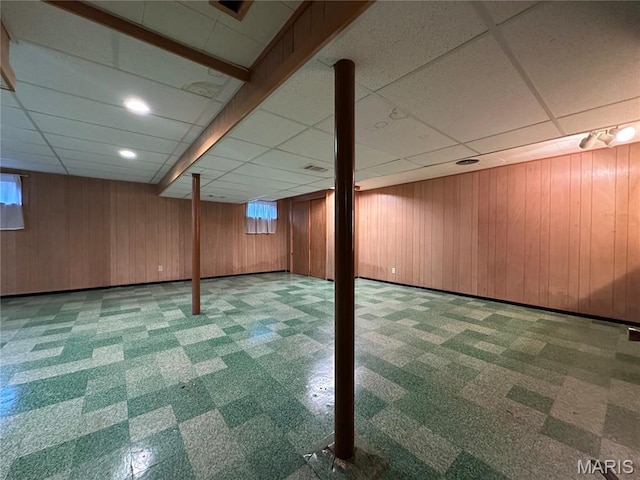 9334 Litzsinger Rd, Rock Hill, MO 63144 - basement featuring a paneled ceiling, carpet floors, and wooden walls