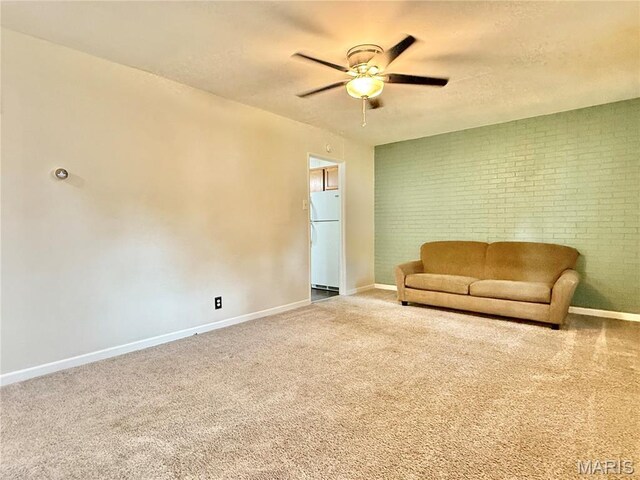 3212 Rodger Ave, Granite City, IL 62040 - sitting room featuring ceiling fan, carpet floors, brick wall, and a textured ceiling