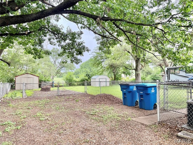 3212 Rodger Ave, Granite City, IL 62040 - fenced backyard with a storage unit and a gate