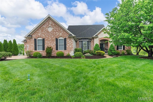 4304 Austin Pass Ct, Saint Charles, MO 63304 - view of front of home with brick siding, a front lawn, and roof with shingles