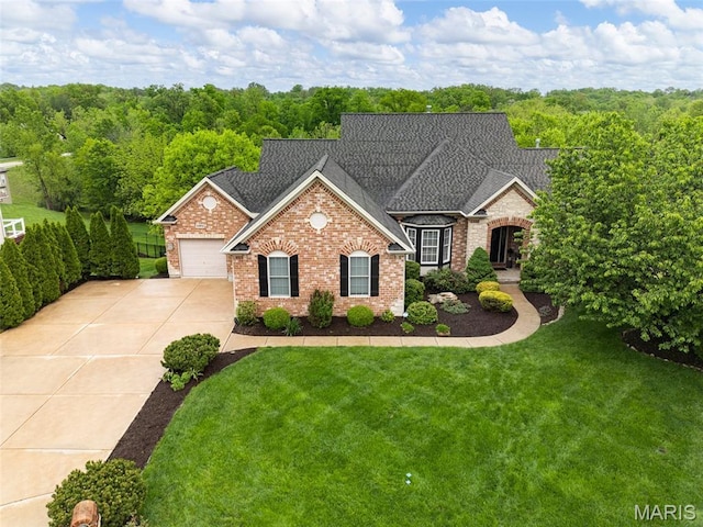 4304 Austin Pass Ct, Saint Charles, MO 63304 - view of front facade featuring brick siding, driveway, an attached garage, a front yard, and a shingled roof