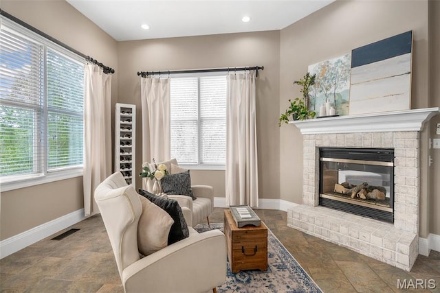 4304 Austin Pass Ct, Saint Charles, MO 63304 - living area with stone finish floors, healthy amount of natural light, and a brick fireplace