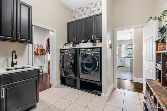 4304 Austin Pass Ct, Saint Charles, MO 63304 - washroom with washing machine and dryer, cabinet space, and light tile patterned flooring